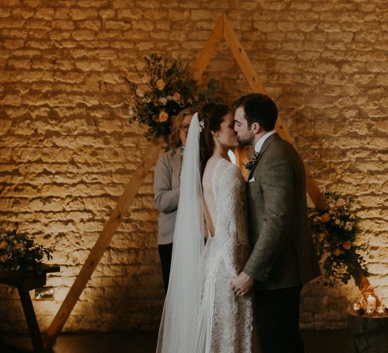 Bride and groom kissing at Lapstone Barn wedding ceremony