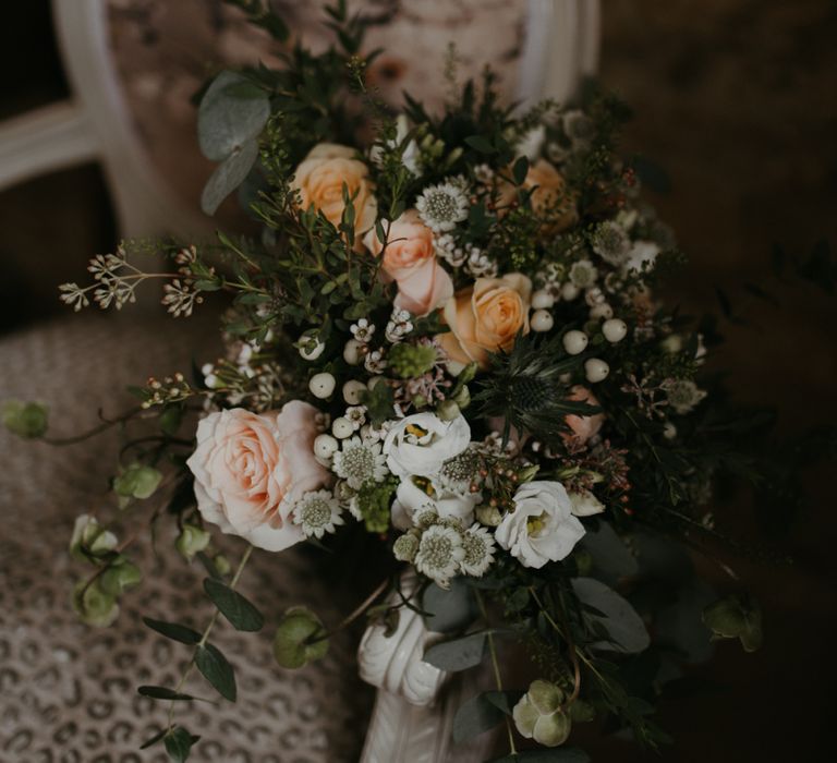 Peach and white flower wedding bouquet with foliage