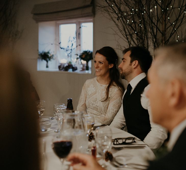 Bride and groom smiling during Lapstone Barn wedding reception