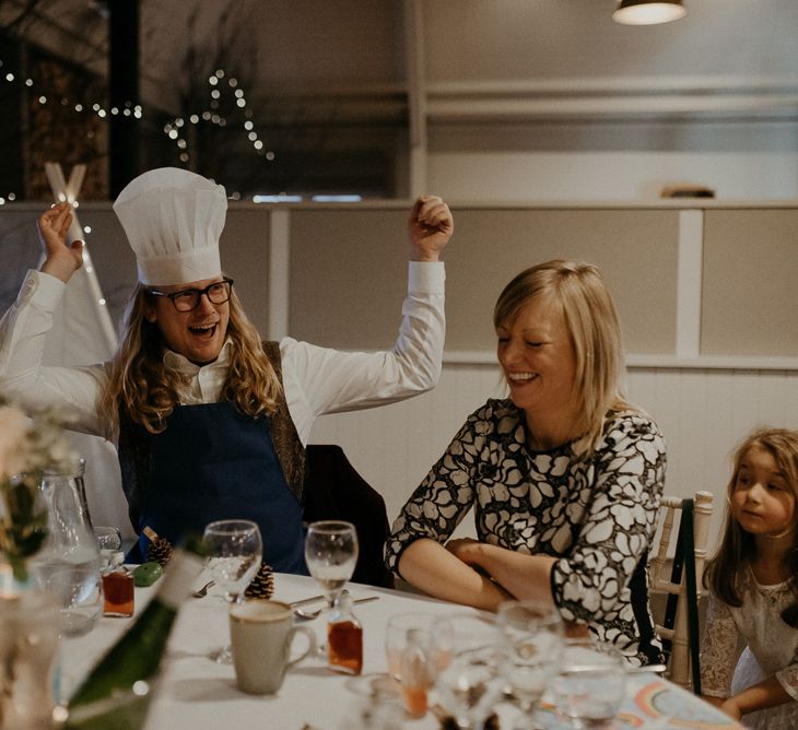 Wedding guest wearing chefs hat during wedding breakfast