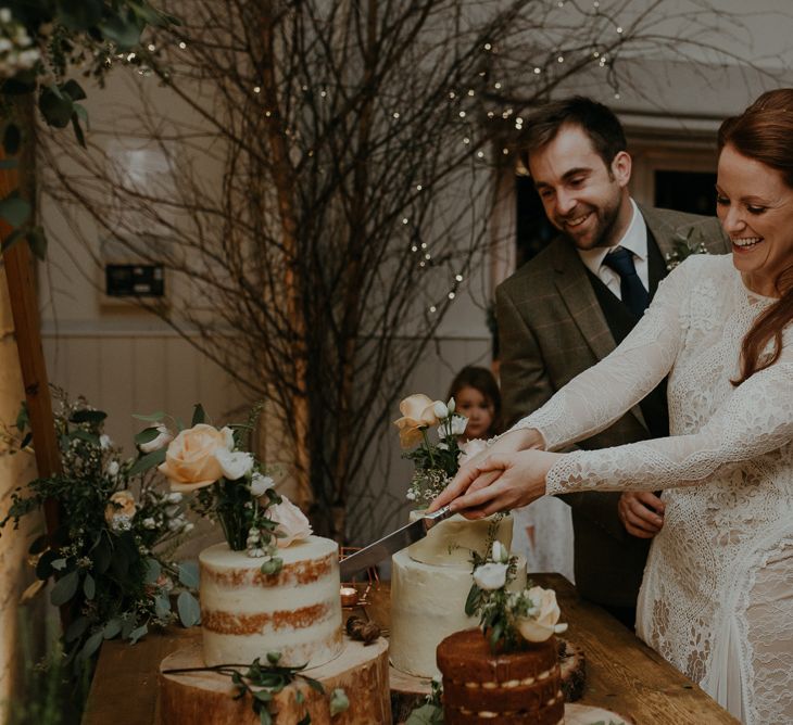 Bride and groom cutting the wedding cake at Lapstone Barn