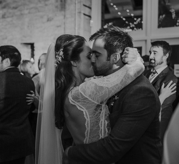 Bride and groom kissing on the dance floor