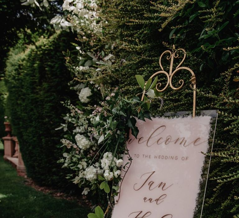 Acrylic wedding sign with flower and foliage decor