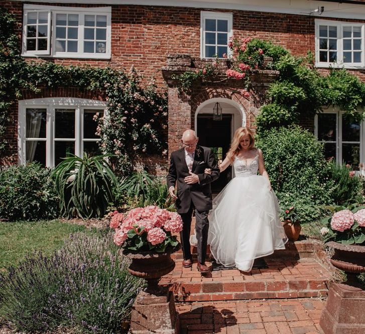 Bride makes her way to ceremony in Hayley Paige wedding dress