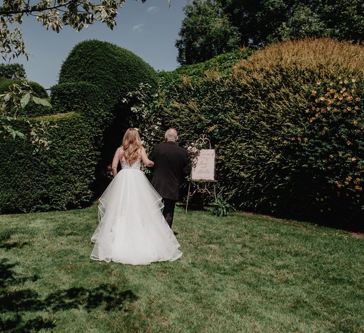 Bride makes her way to ceremony in Hayley Paige wedding dress