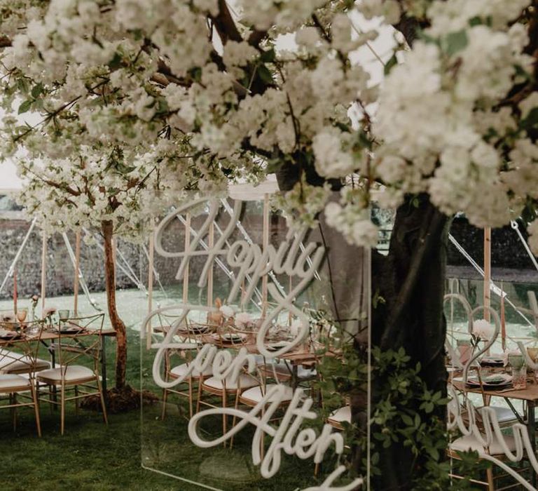 Cherry blossom wedding decor with acrylic neon signs