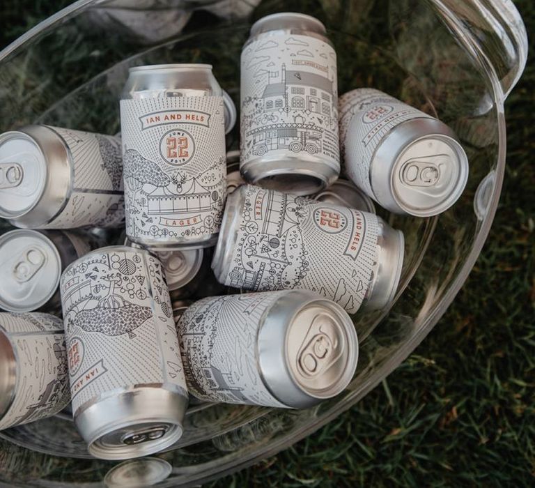 Personalised cans of beer and Prosecco wall at wedding