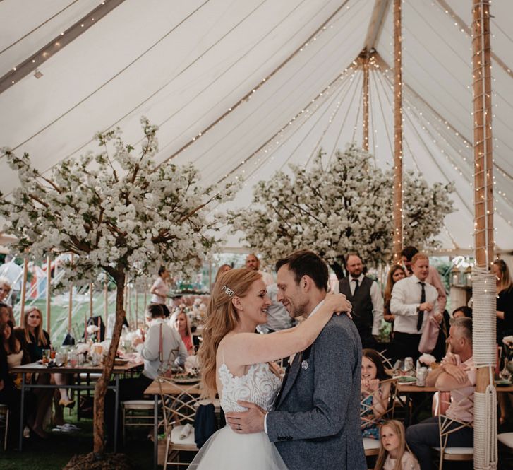 Bride and groom first dance under fairy lights and amongst trees from Twilight Trees