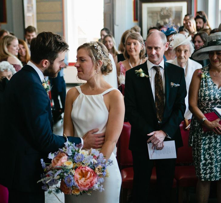 Bride in Halterneck Charlie Brear wedding Dress with Colourful Bouquet