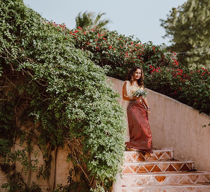 Bridesmaid in burgundy and gold dress