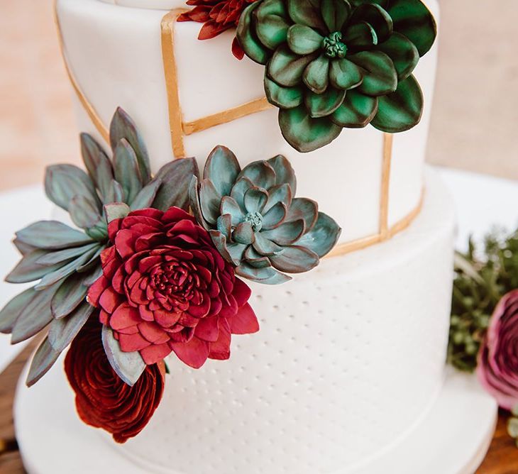 Wedding cake detail with red flowers