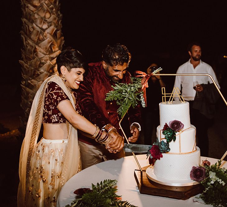 Bride and groom cut the wedding cake