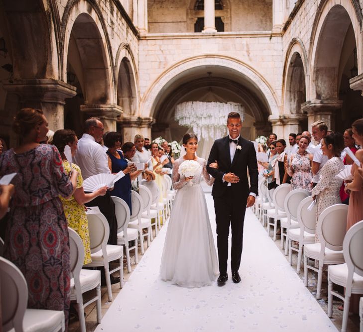 Bride and Groom Just Married Walking Down the Aisle of at 16 Century Palace in Croatia