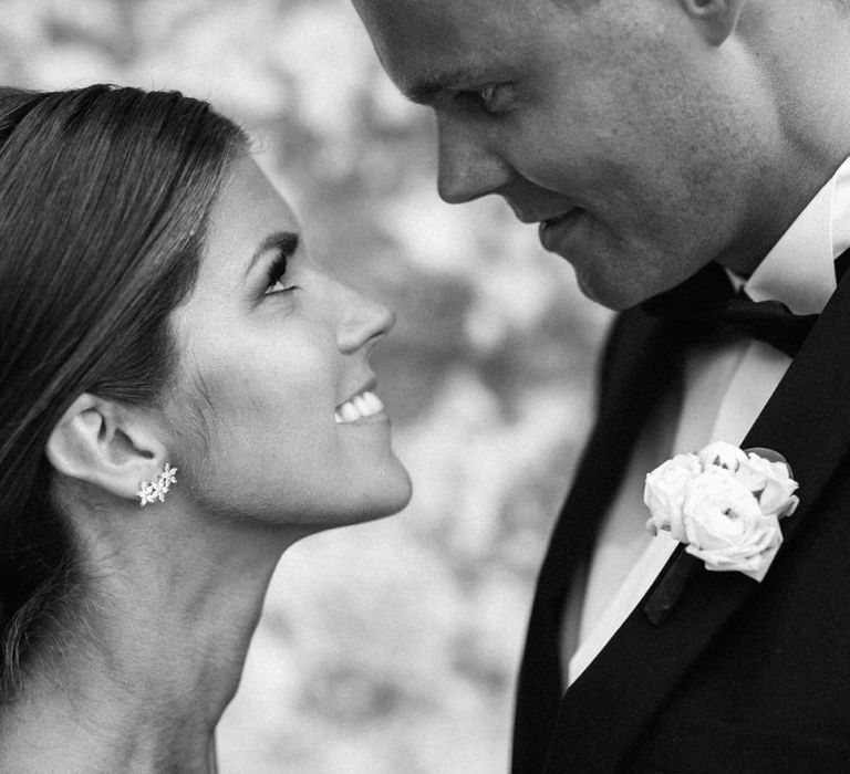 Black and White Portrait of Bride and Groom Looking into Each Others Eyes