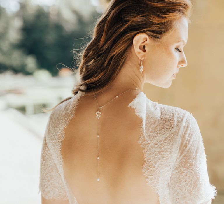 Bride in Low Back Wedding Dress Wearing a Back Necklace