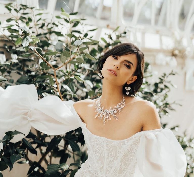 Bride in Off the Shoulder Wedding Dress Wearing an Ornate Necklace