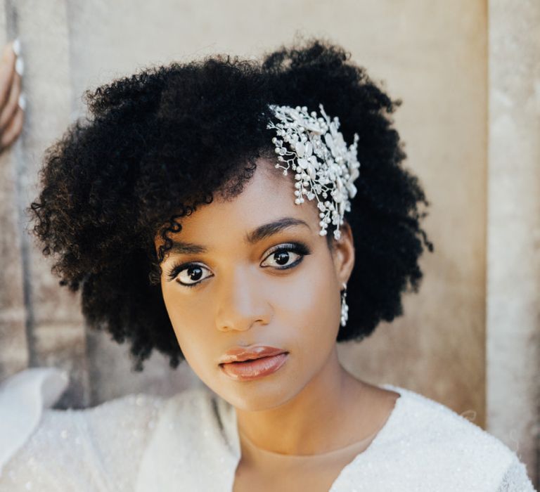 Black Bride with Afro Hair Wearing an Ornate Pearl Hair Accessory