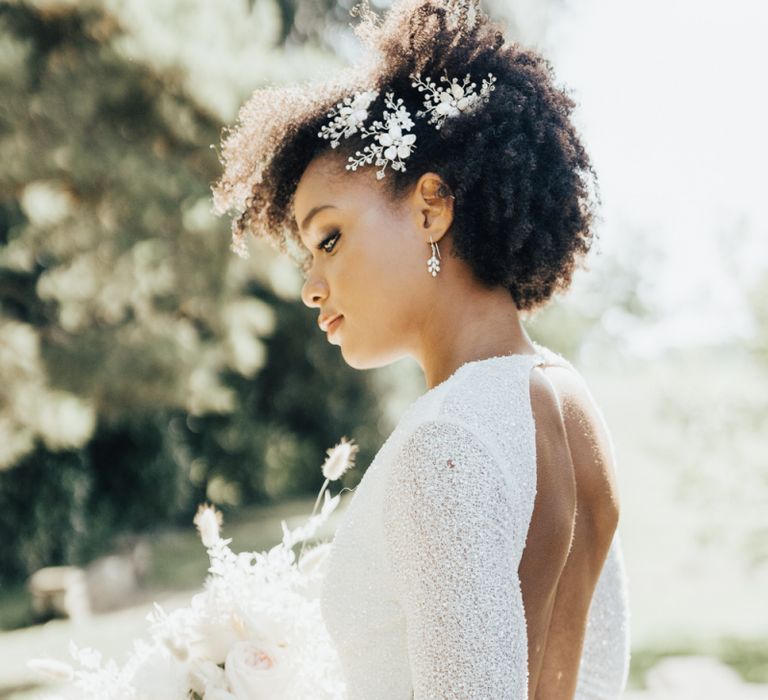 Black Bride with Afro Hair Wearing a Backless, Shimmering Emma Beaumont Wedding Dress