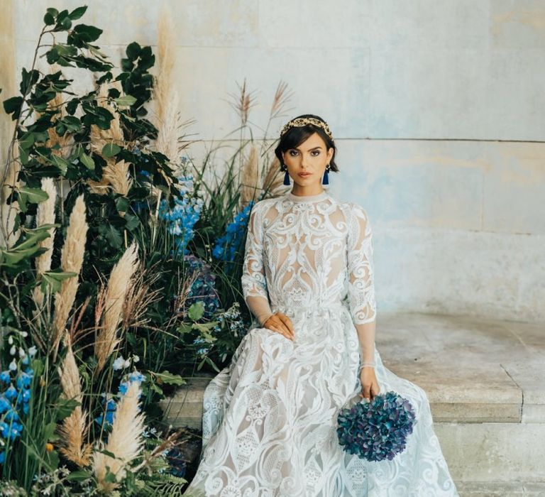 Bride in Lace Wedding Dress Holding a Blue Hydrangea Bouquet