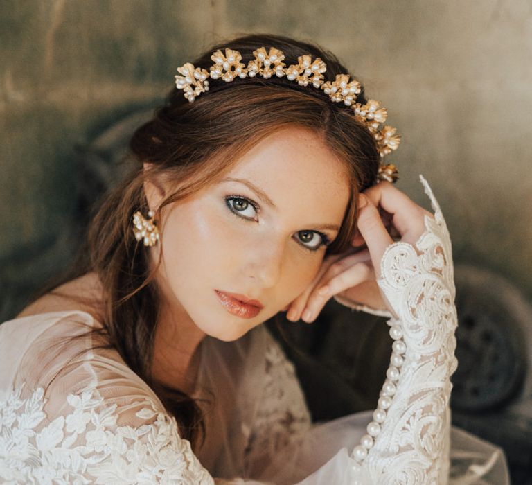 Bride in Emma Beaumont Wedding Dress with Peal Buttons on the Cuffs  wearing a Gold and Pearl Hair Accessory and Matching Earrings