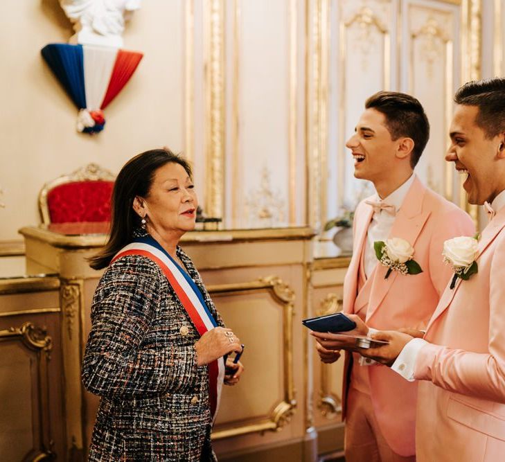 Grooms receiving official certificate at intimate Paris  ceremony in the city hall