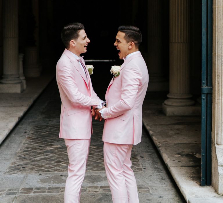 Two grooms in pink wedding suits do first look at Paris ceremony