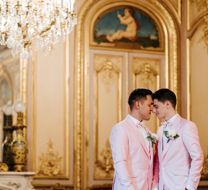 Grooms embrace wearing pink wedding suits at same-sex ceremony in Paris