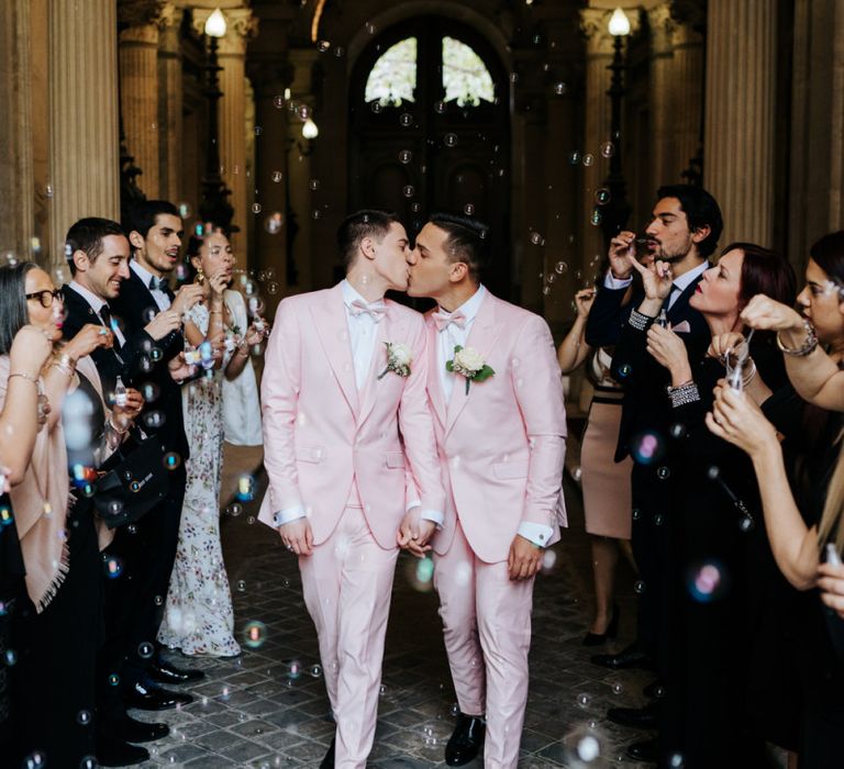 Bubble confetti moment with small champagne bottles at city hall same-sex ceremony in Paris