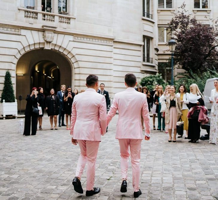 Two grooms in pink wedding suits do first look at Paris ceremony