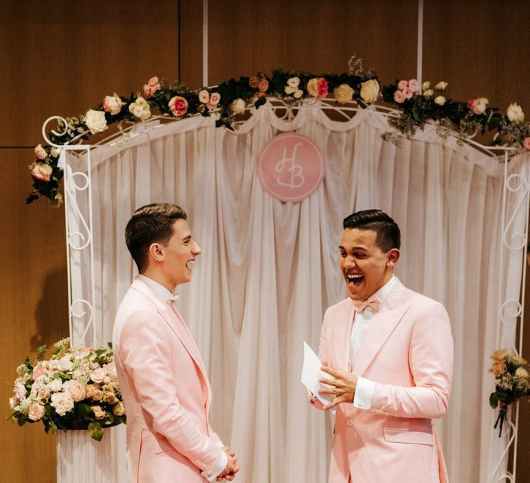 Grooms reading  their vows  during same sex ceremony in Paris