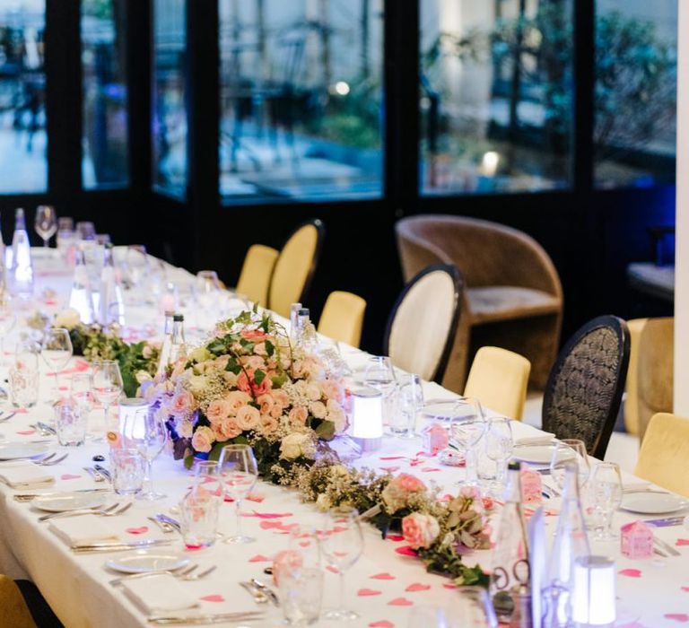 Table setting decor with white and pink rose floral arrangement at intimate Paris reception