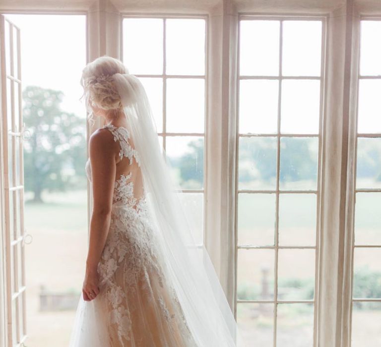 Bride in Pronovias Wedding Dress Looking Out The Window