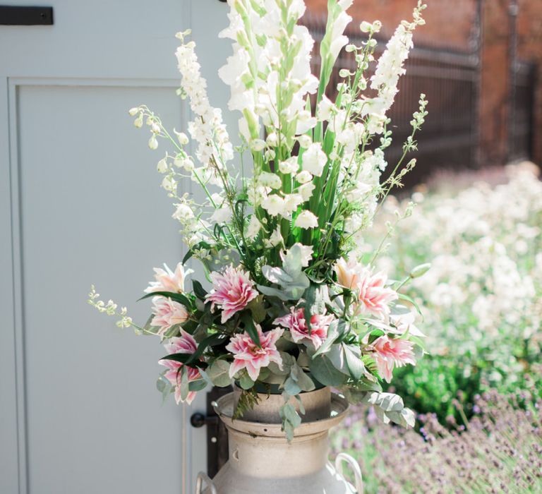 White and Pink Flower Filled Milk Churn