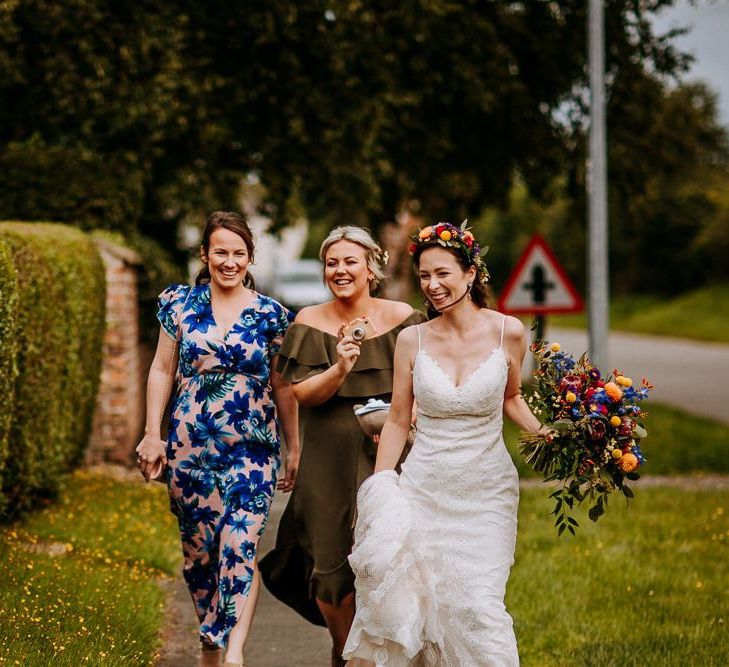 Bride in Lace Sottero &amp; Midgley Wedding Dress Walking Down the Lane with Her Bridesmaids