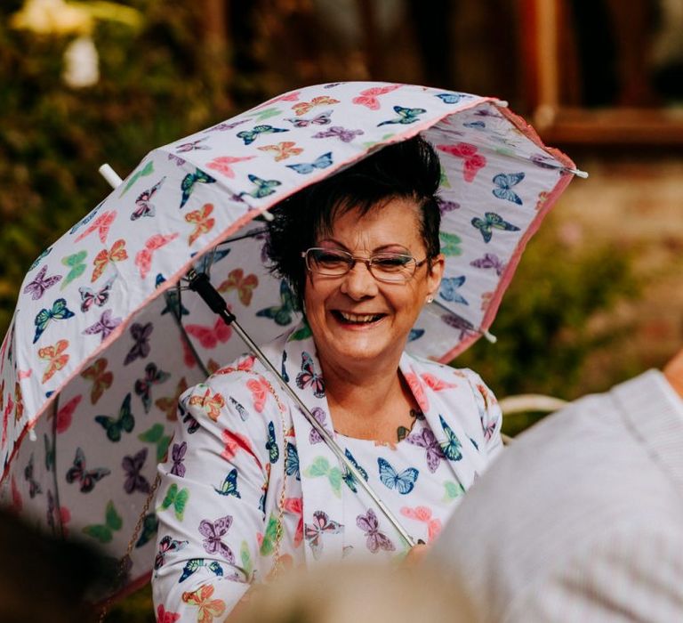 Wedding Guest in Matching Outfit and Umbrella