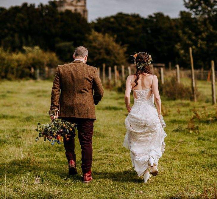 Bride in Sottero &amp; Midgley Wedding Dress and Flower Crown and Groom in Brown Wool Suit