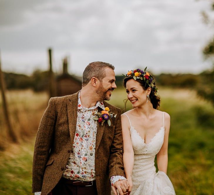 Bride in Sottero &amp; Midgley Wedding Dress and Colourful Flower Crown and Groom in Brown Wool Suit and Floral Shirt