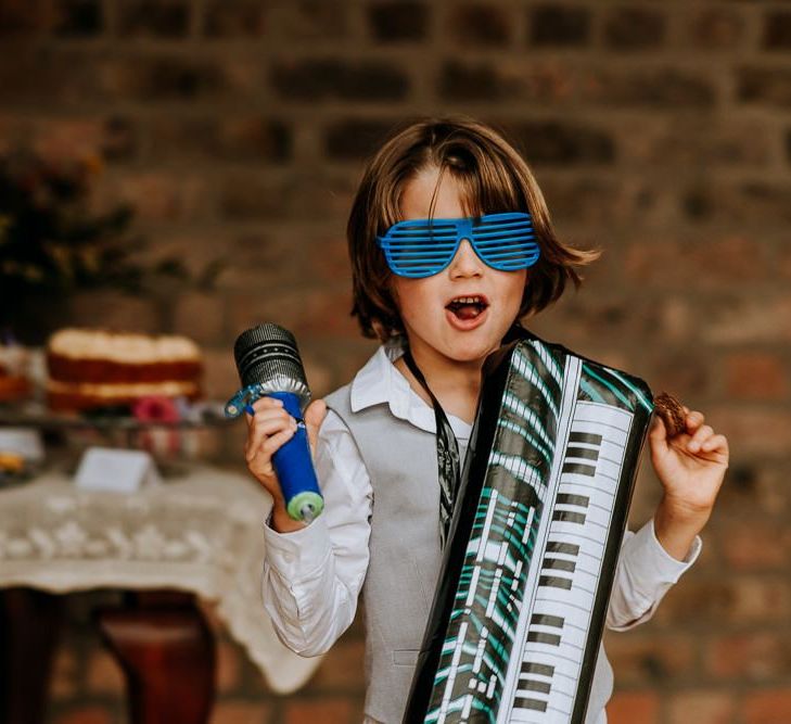 Little Wedding Guest with Inflatable Keyboard and Glasses