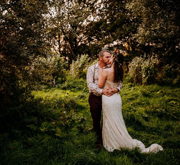 Bride in Sottero &amp; Midgley Wedding Dress and Colourful Flower Crown and Groom in Floral Shirt