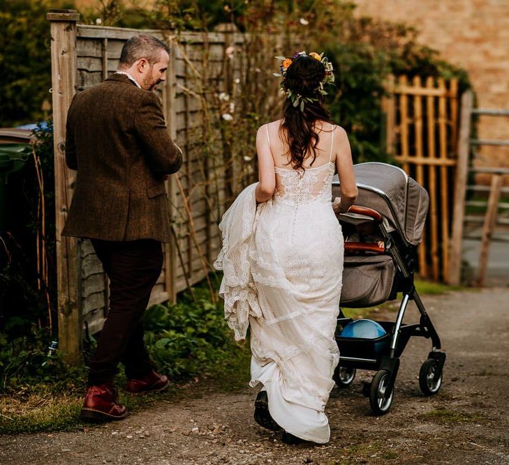 Bride in Sottero &amp; Midgley Wedding Dress and Colourful Flower Crown and Groom in Brown Suit