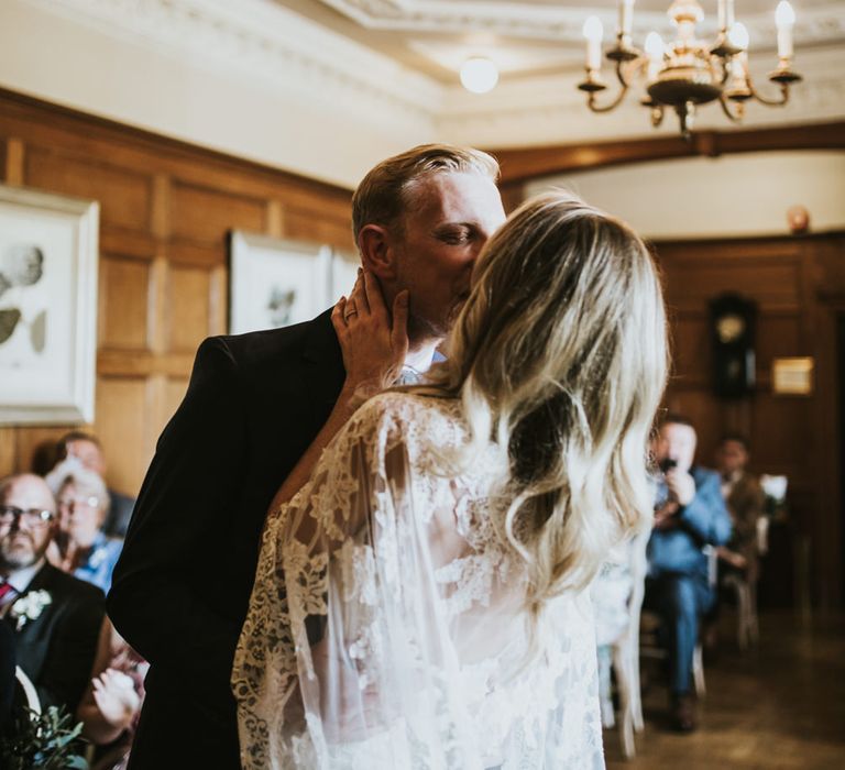 Wedding Ceremony | Bride in Pronovias Oringo Lace Bridal Gown &amp; Cape | Groom in Blue Marks and Spencer Suit | Green, White &amp; Gold Wedding at Buckland Tout Saints, Devon |  Darina Stoda Photography