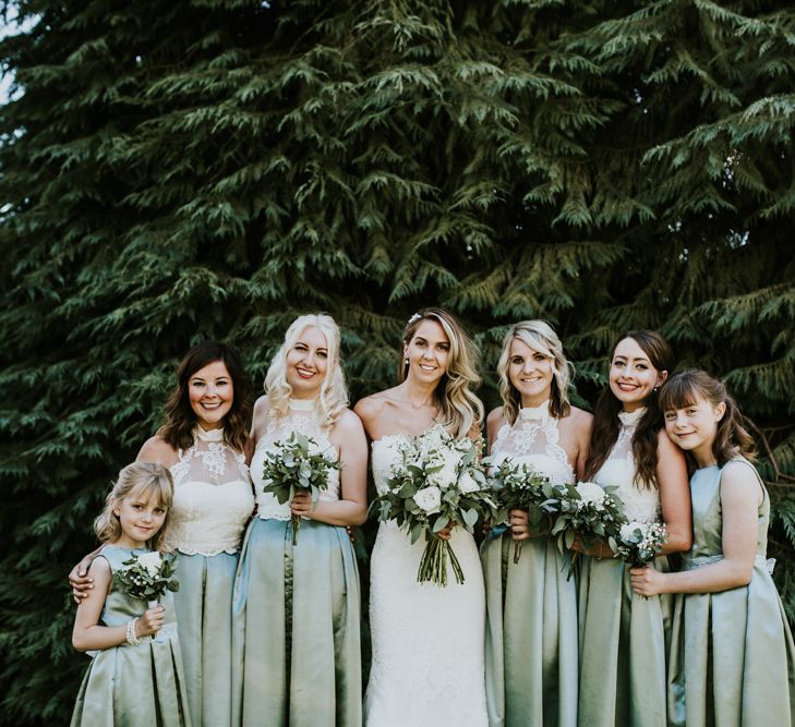 Bridal Party | Bridesmaids in Mint Green Homemade Skirts &amp; ASOS Tops | Bride in Pronovias Oringo Lace Bridal Gown &amp; Cape | Green, White &amp; Gold Wedding at Buckland Tout Saints, Devon |  Darina Stoda Photography