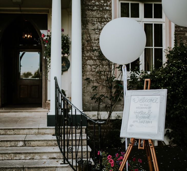 Welcome Wedding Sign &amp; Giant Balloon | Green, White &amp; Gold Wedding at Buckland Tout Saints, Devon |  Darina Stoda Photography