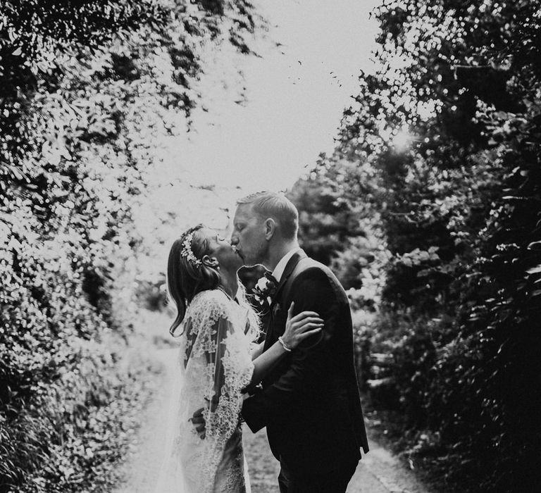 Bride in Pronovias Oringo Lace Bridal Gown &amp; Cape | Groom in Blue Marks and Spencer Suit | Green, White &amp; Gold Wedding at Buckland Tout Saints, Devon |  Darina Stoda Photography