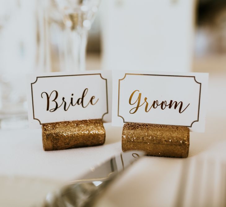 Bride &amp; Groom Place Names in Glitter Corks | Green, White &amp; Gold Wedding at Buckland Tout Saints, Devon |  Darina Stoda Photography