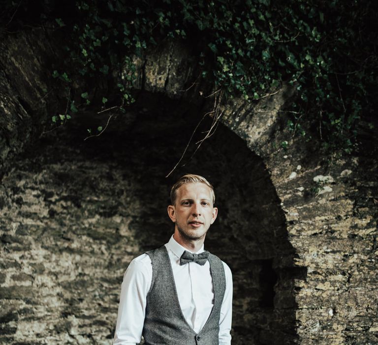 Groom in Tweed Waistcoat &amp; Blue Marks and Spencer Suit | Green, White &amp; Gold Wedding at Buckland Tout Saints, Devon |  Darina Stoda Photography