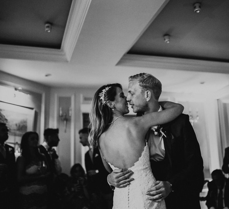 First Dance | Bride in Pronovias Oringo Lace Bridal Gown &amp; Cape | Groom in Blue Marks and Spencer Suit | Green, White &amp; Gold Wedding at Buckland Tout Saints, Devon |  Darina Stoda Photography