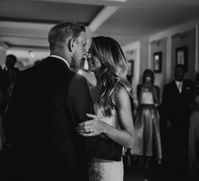 First Dance | Bride in Pronovias Oringo Lace Bridal Gown &amp; Cape | Groom in Blue Marks and Spencer Suit | Green, White &amp; Gold Wedding at Buckland Tout Saints, Devon |  Darina Stoda Photography