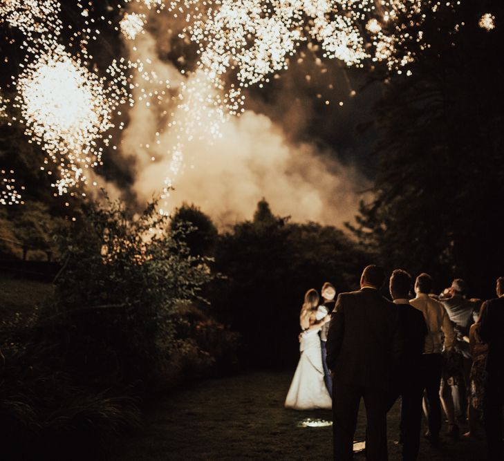 Surprise Fireworks Display | Bride in Pronovias Oringo Lace Bridal Gown &amp; Cape | Groom in Blue Marks and Spencer Suit | Green, White &amp; Gold Wedding at Buckland Tout Saints, Devon |  Darina Stoda Photography