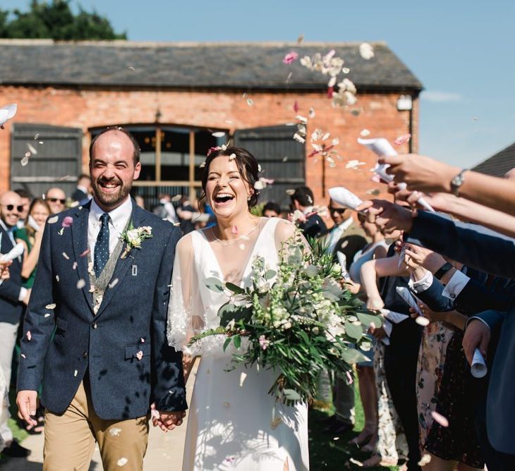 Confetti exit and white wedding flowers bouquet